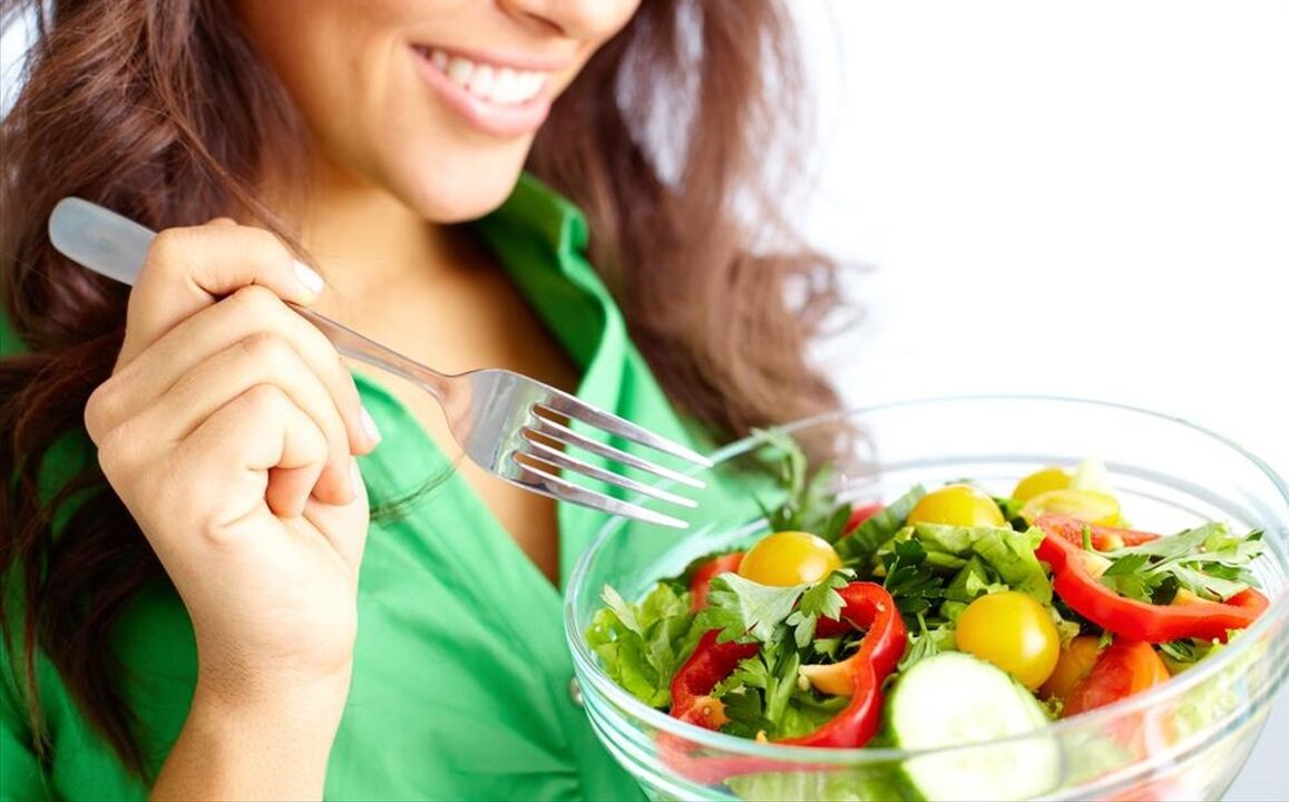 Girl eating vegetable salad on a 6 flower diet